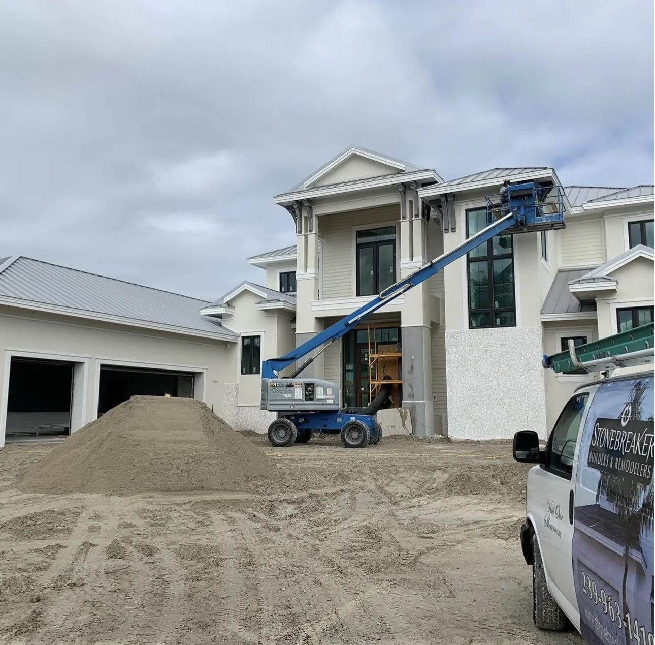 Finished stucco residence with exterior work in progress