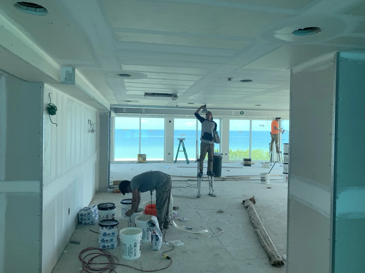 Drywall finishing in progress inside a coastal luxury residence
